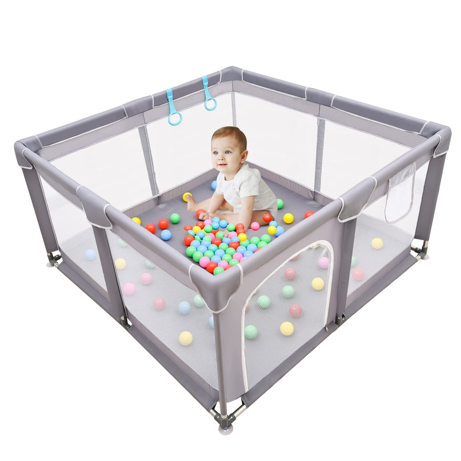 Baby in playard with balls
