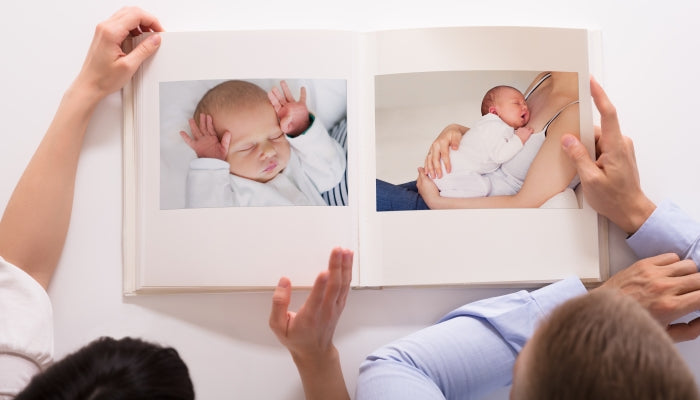 Parents look at book of their children