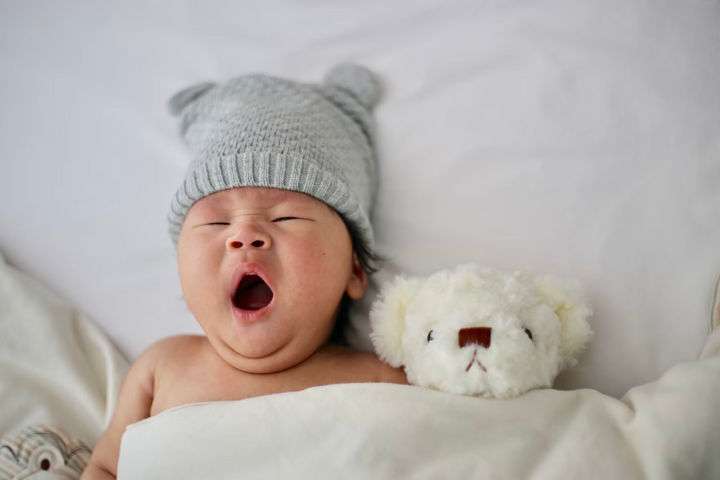 A baby yawning in his sleep