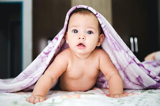 Baby underneath a blanket