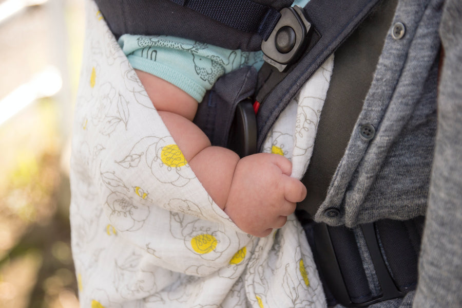 the arm of a baby in a car seat