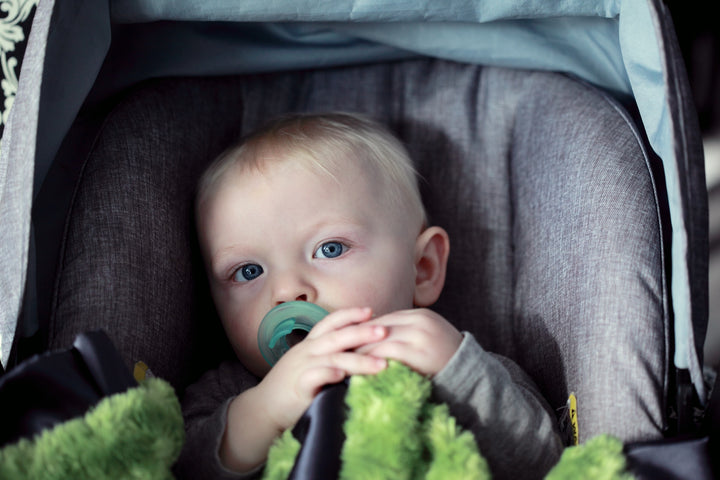  A baby sits in a gray car seat