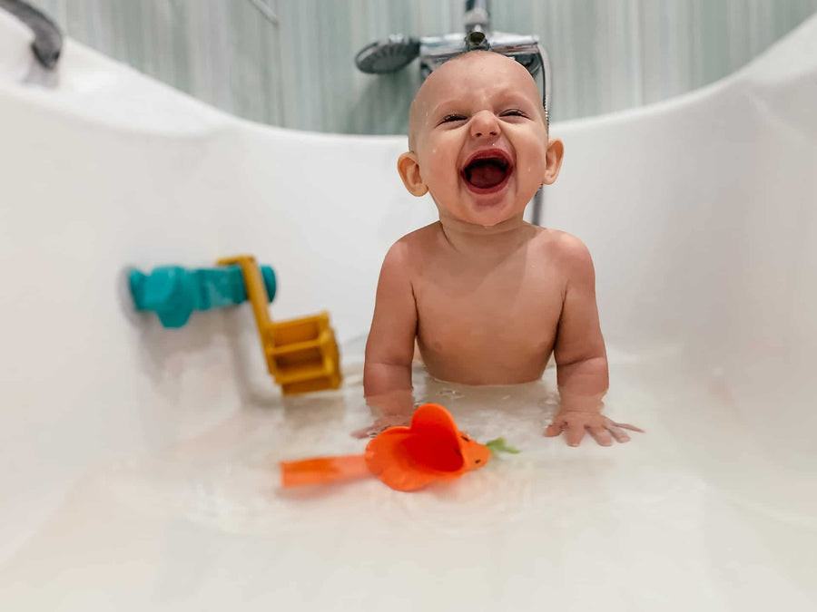 Baby playing with toys in the bath