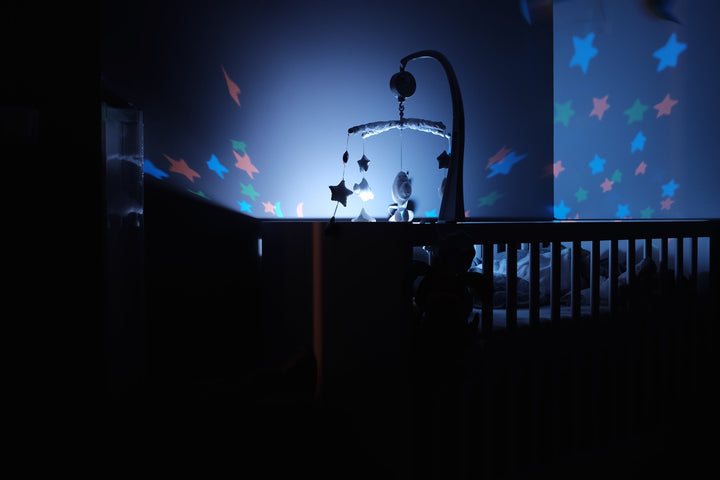 nursery crib at night with star lights