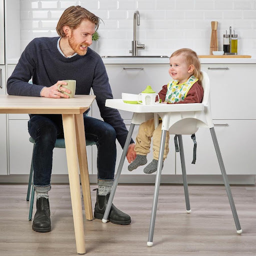 Dad with baby in high chair