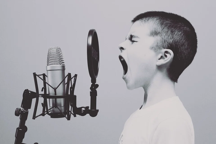 child shouting at the microphone