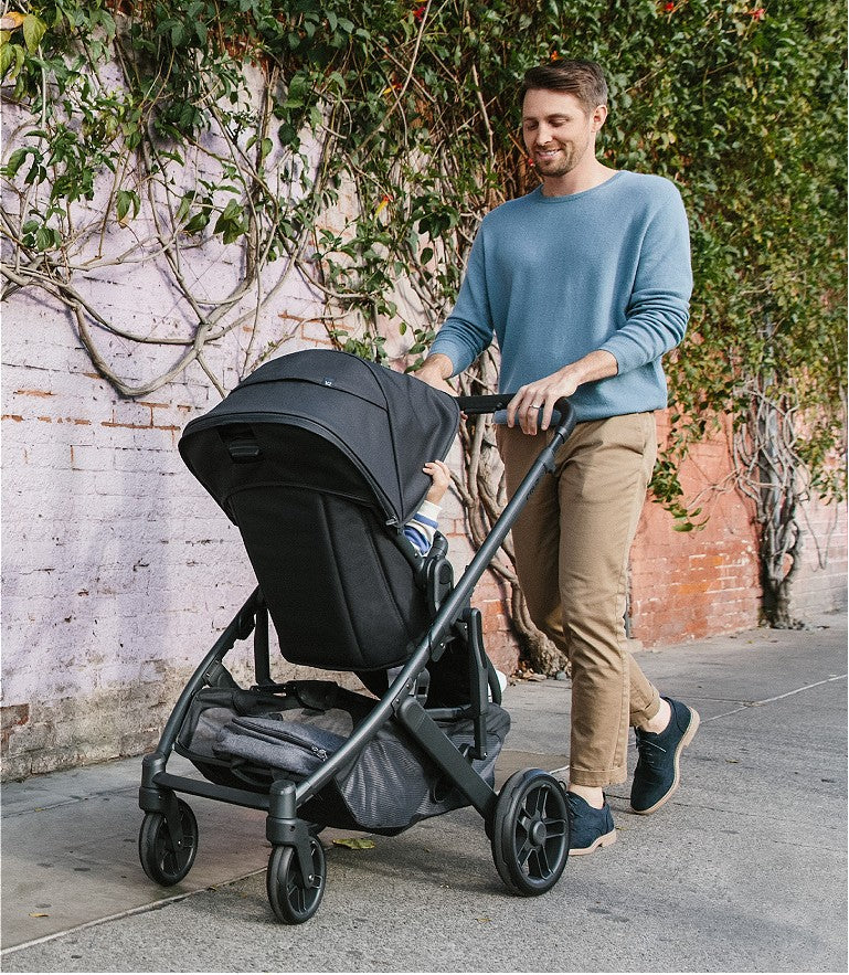 a dad pushing an Uppababy stroller