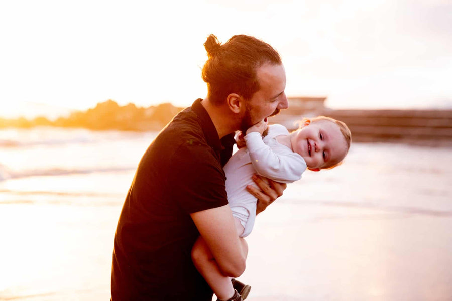 Man holding baby in sun