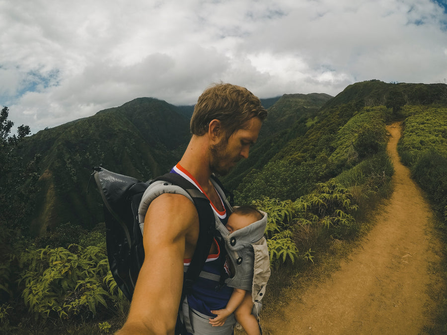 dad wearing a baby carrier while hiking