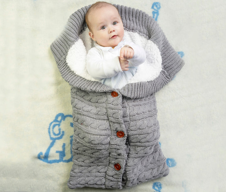a baby in a winter sleep sack