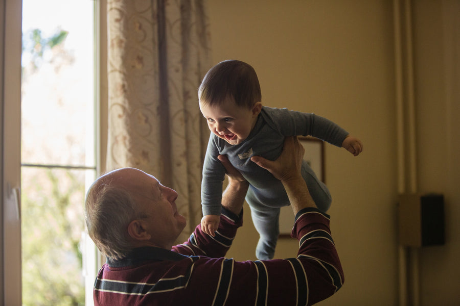 grandpa holding a baby in the air