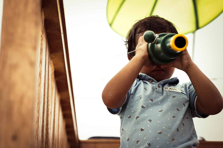 Child holding binoculars