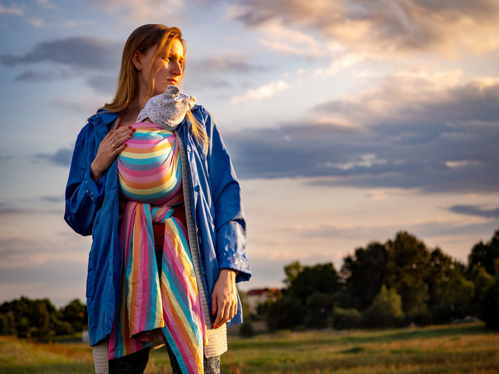 woman holding a baby close with a baby wrap