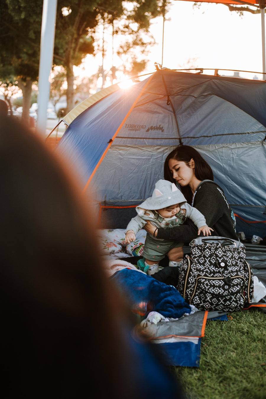 mother camping and holding her baby