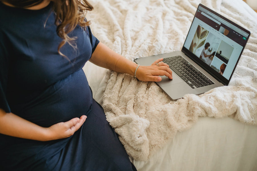 a pregnant woman on a computer
