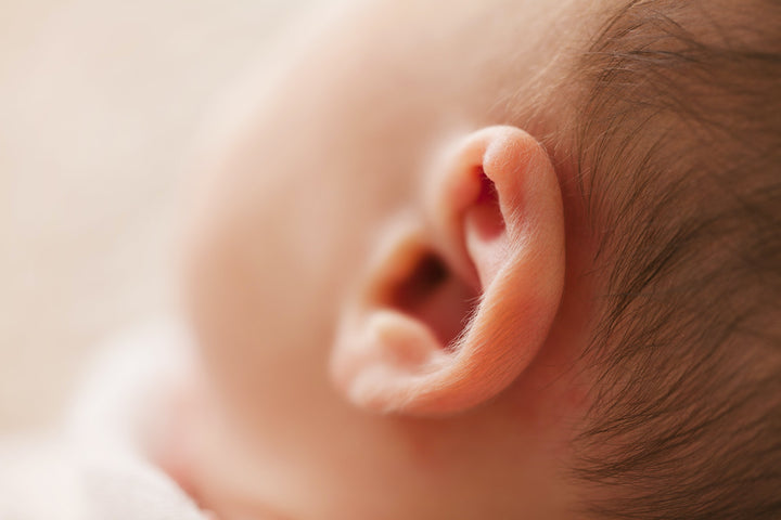 a close up of a baby’s ear
