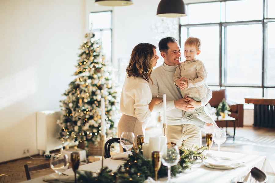 A family stands around a decorated holiday table