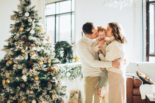 parents kissing their December baby