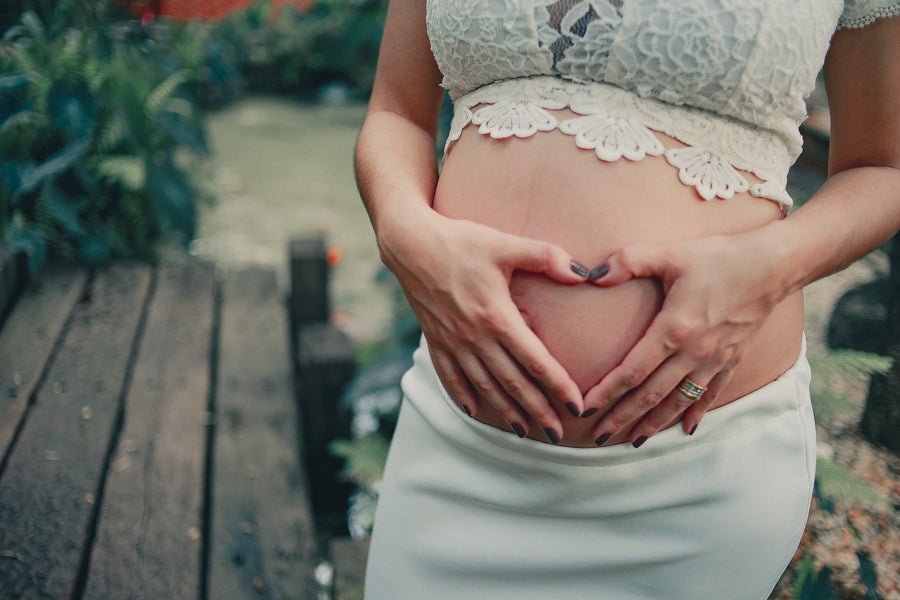  pregnant woman holding her stomach