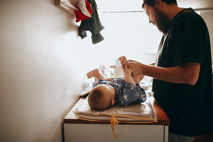 Dad changing baby’s diaper