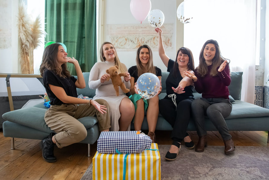  A group of women cheer at a baby shower