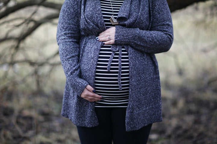 a woman wearing plus-size maternity clothing