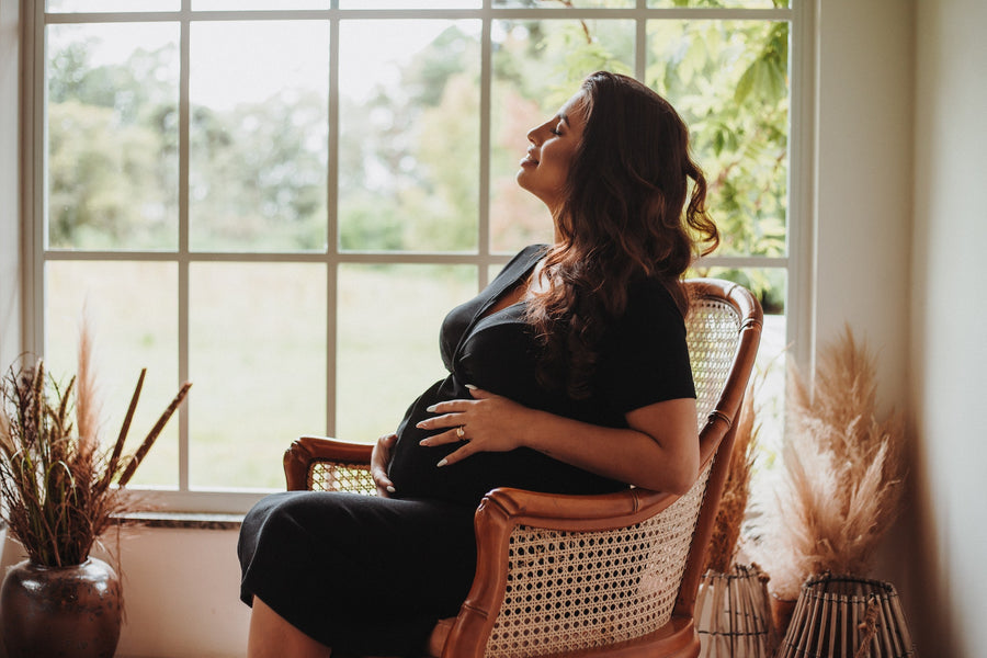 pregnant woman smiling while seated