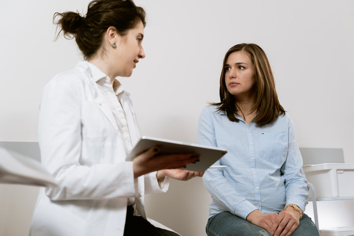 woman sitting next to doctor at a prenatal appointment