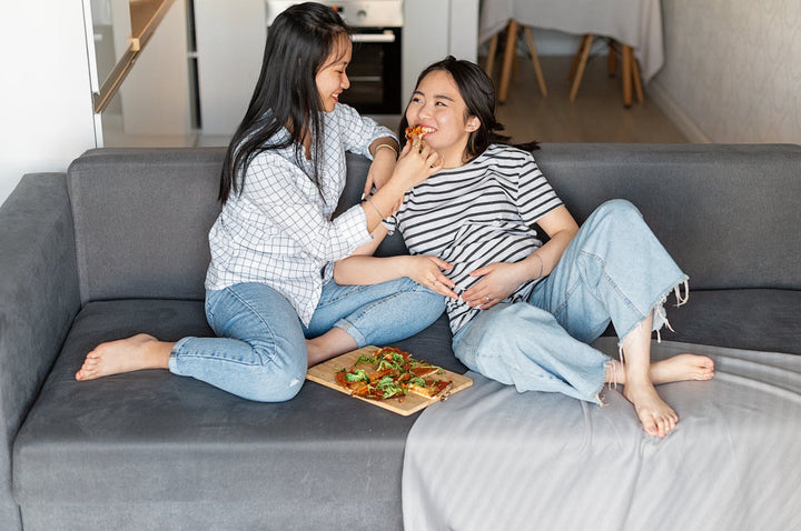  pregnant woman eating with a friend