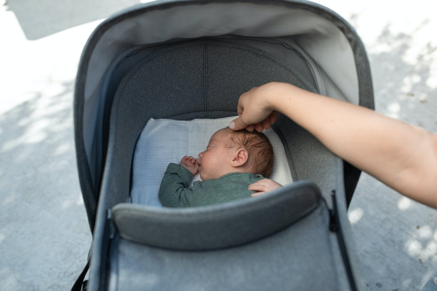 baby sleeping in a travel system