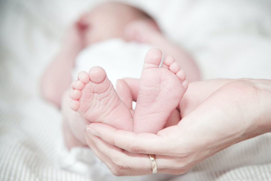A person holds a baby's feet