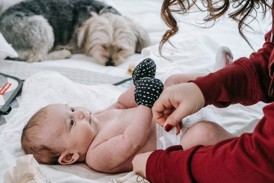 mom changing baby’s diapers