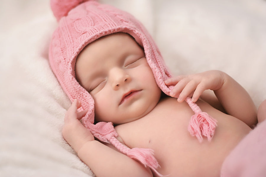Newborn with a pink winter hat on