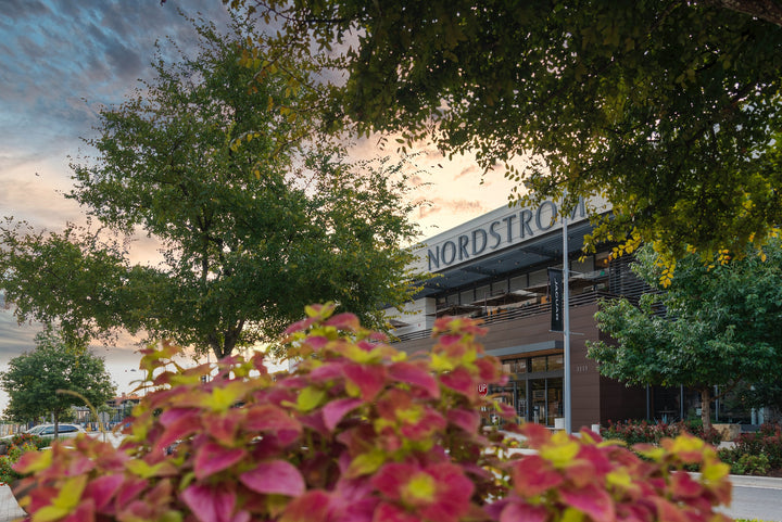 A Nordstrom building peeks through the colorful landscape