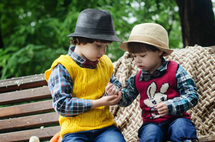 Two young kids sharing something 