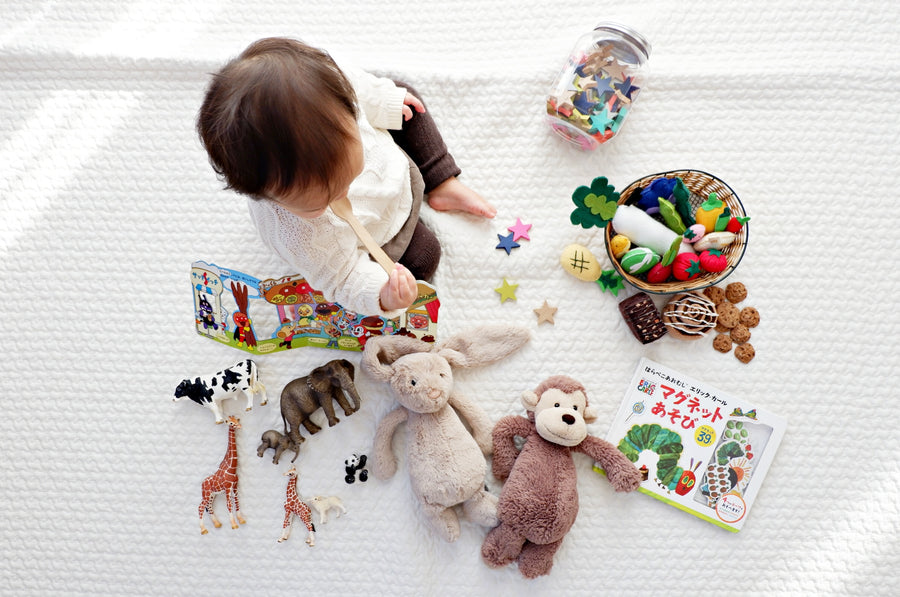 a baby playing with a lot of toys